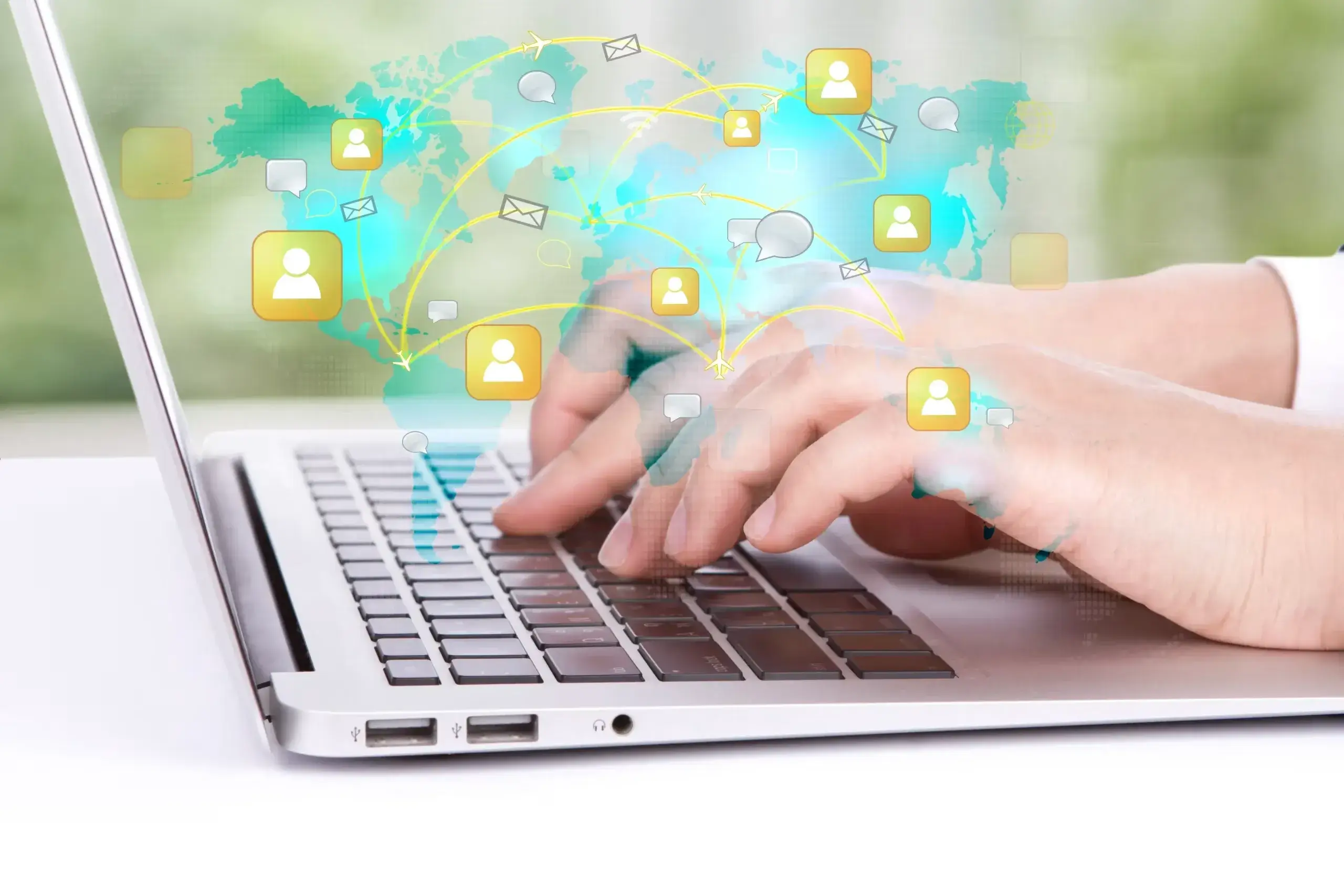 Blog 20 Hands typing on a laptop with global communication icons overlayed, symbolizing internet connectivity and digital interaction.